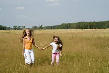 Image showing Girls plays on a meadow II