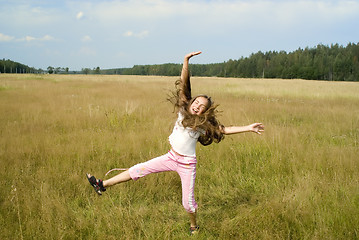 Image showing Girl plays on a meadow