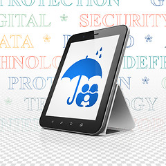 Image showing Safety concept: Tablet Computer with Family And Umbrella on display
