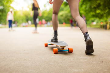 Image showing Teenage girl urban long board riding.