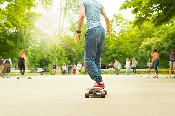 Image showing Teenage girl practicing riding long board.