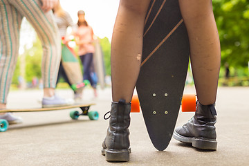 Image showing Teenage girl urban long board riding.