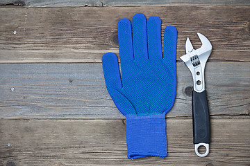 Image showing Blue construction glove and wrench