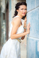 Image showing woman in a white dress near the old stone wall