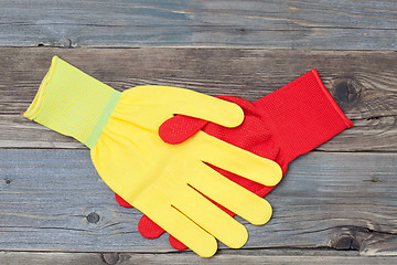 Image showing handshake red and yellow construction gloves