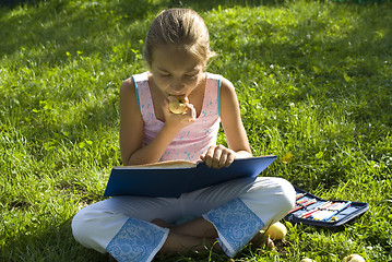 Image showing The girl draws on a meadow II