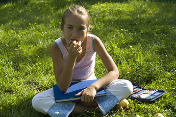 Image showing The girl draws on a meadow III