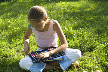 Image showing The girl draws on a meadow IV