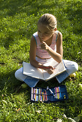 Image showing The girl draws on a meadow V