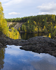 Image showing Wild pond on rock in forest in autumn