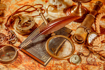 Image showing Vintage magnifying glass lies on an ancient world map