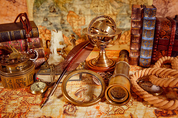 Image showing Vintage magnifying glass lies on an ancient world map