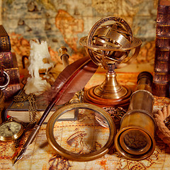 Image showing Vintage magnifying glass lies on an ancient world map