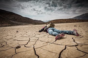 Image showing Person lays on the dried ground