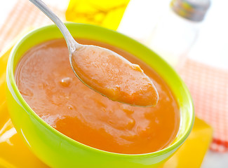 Image showing Fresh soup from pumpkin in the green bowl