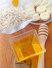 Image showing Honey in the glass bowl on the wooden table