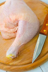 Image showing Raw chicken and knife on the wooden board