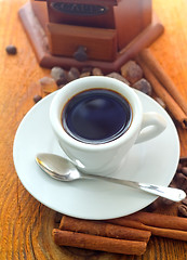 Image showing Fresh aroma coffee in the white cup, coffee and cinnamon