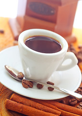 Image showing Fresh aroma coffee in the white cup, coffee and cinnamon