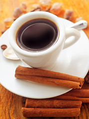 Image showing Fresh aroma coffee in the white cup, coffee and cinnamon