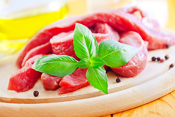 Image showing raw meat on the wooden board