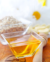 Image showing Honey in the glass bowl on the wooden table