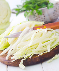 Image showing Raw cabbage and knife on the wooden board