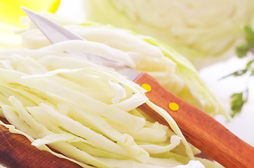 Image showing Raw cabbage and knife on the wooden board