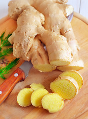 Image showing Fresh ginger and knife on the wooden board