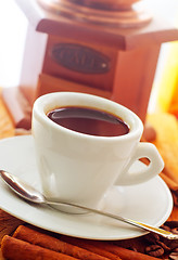 Image showing Fresh aroma coffee in the white cup, coffee and cinnamon