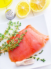 Image showing Raw salmon on the white plate with thyme and salt