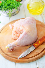 Image showing Raw chicken and knife on the wooden board