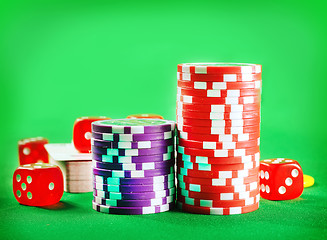 Image showing Chips for poker and cubes on the green background