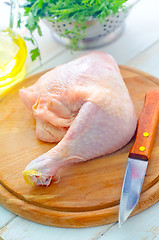 Image showing Raw chicken and knife on the wooden board