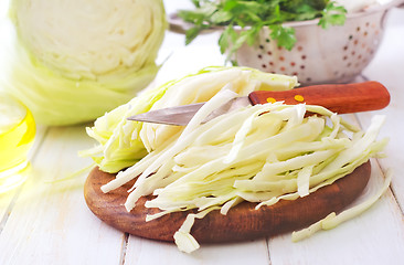 Image showing Raw cabbage and knife on the wooden board