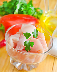 Image showing raw chicken and raw vegetables on wooden table