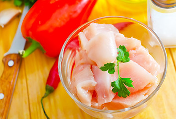 Image showing raw chicken and raw vegetables on wooden table