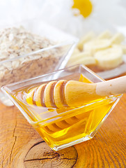 Image showing Honey in the glass bowl on the wooden table