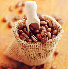 Image showing Aroma coffee in the sack on the wooden board