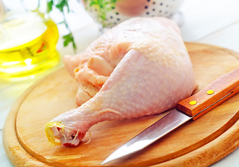 Image showing Raw chicken and knife on the wooden board