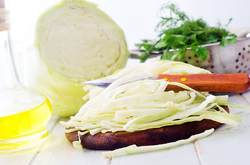 Image showing Raw cabbage and knife on the wooden board