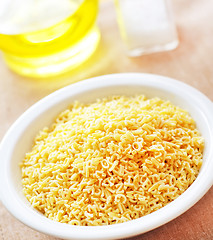 Image showing assortment of raw pasta and wheat on wooden background