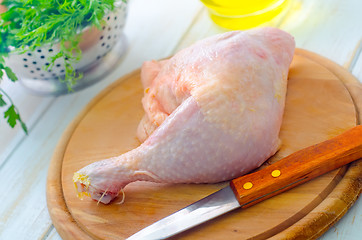 Image showing Raw chicken and knife on the wooden board