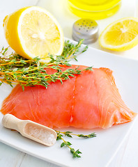Image showing Raw salmon on the white plate with thyme and salt