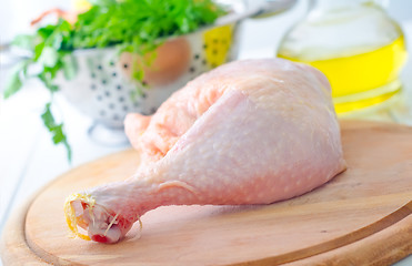 Image showing Raw chicken and knife on the wooden board
