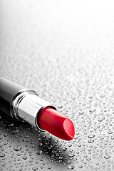 Image showing lipstick closeup with desatured water drops