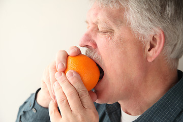 Image showing senior man with orange