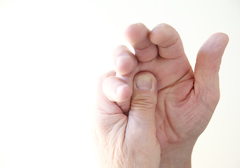 Image showing man with pain at base of fingers