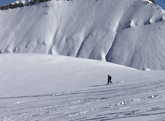 Image showing Snowboarder downhill on off piste slope with newly-fallen snow