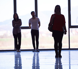 Image showing student girl standing with laptop, people group passing by